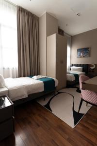 Postel nebo postele na pokoji v ubytování Hotel Royal