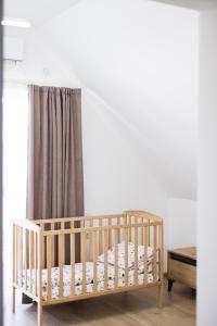 a crib in a room with a curtain at Апартаменти Velvet Rooms in Skhidnitsa