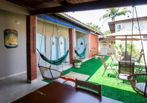 a patio with hammocks on a house at Pousada Petit Refuge in Juquei
