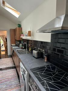 a kitchen with a black and white counter top at Harringtons in Nottingham +14 photos