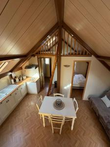 a attic room with a table and a bed at Chalet Mo in Bagnères-de-Bigorre