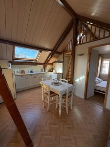 a kitchen and dining room with a table and chairs at Chalet Mo in Bagnères-de-Bigorre +6 photos
