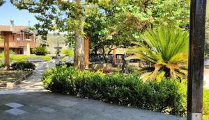 a park with trees and bushes and a building at La Piccola Valle in Vallefiorita