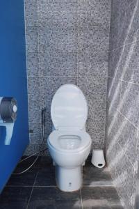 a bathroom with a white toilet in a stall at Kawinlodge khanom in Ban Thung O