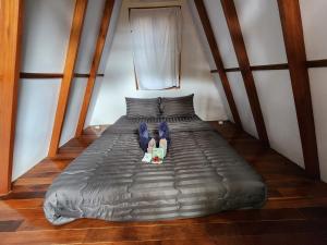 a person laying on a bed in a room at Kawinlodge khanom in Ban Thung O