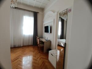 a small room with a desk and a window and a room with a deskablish at MIMFRI guest house,hotel in Tashkent