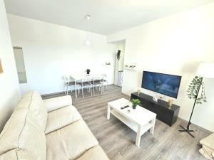 a living room with a white couch and a table at Marianne, Apartament 2 Camere, Viilor 9 in Chiajna