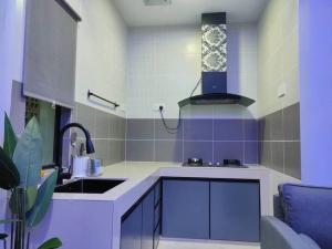 a kitchen with a sink and a counter top at Delle Home in Petaling Jaya