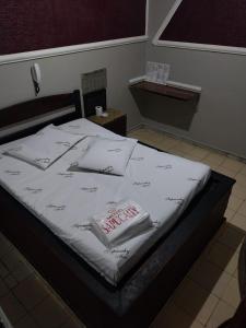 En eller flere senge i et værelse på Motel Sapucahy