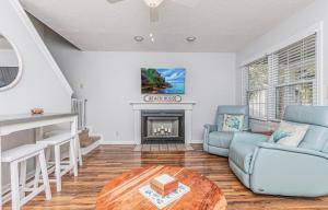 a living room with a couch and a fireplace at Seaside Haven in Myrtle Beach