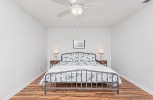 a bedroom with a bed and a ceiling fan at Seaside Haven in Myrtle Beach +17 photos
