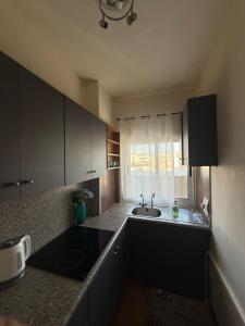 a small kitchen with a sink and a window at Poseidon Breeze in Limassol
