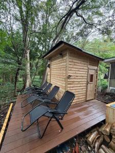 a group of chairs on a deck with a cabin at Rose Garden Esta in Kashiwa