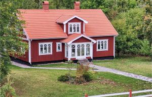 a red house with an orange roof at Gorgeous Home In Älmeboda With Sauna in Älmeboda +14 photos