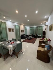 a large living room with a table and chairs at Colonel's Abbey First Floor in Jaipur