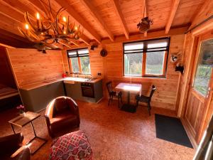 a room with a kitchen and a table in a cabin at Heerlijk vertoeven achter de groentetuin in Epe