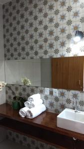 a bathroom with a sink and a counter with towels at Lagoa Seca Hotel Rural in São Lourenço +70 photos