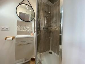 a bathroom with a shower and a mirror at Armonid au coeur de Cabourg in Cabourg