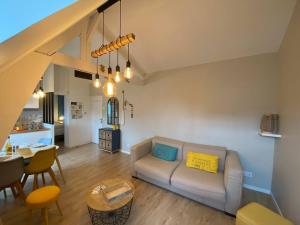 a living room with a couch and a table at Armonid au coeur de Cabourg in Cabourg