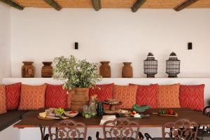 a dining room with a table with red and orange pillows at Firemasters House Historic Church Street in Tulbagh in Tulbagh