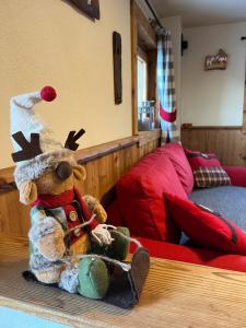 a stuffed animal sitting on a table in a bedroom at Alpine Dream House - Chalet in Gressan +27 photos