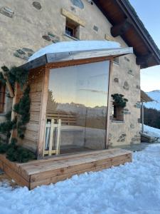 a building with a large window in the snow at Alpine Dream House - Chalet in Gressan