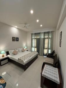 a bedroom with a large bed and a window at Colonel's Abbey First Floor in Jaipur