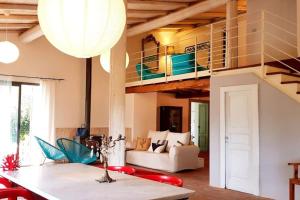 a living room with a loft with a staircase at L'Aranceto in Acireale