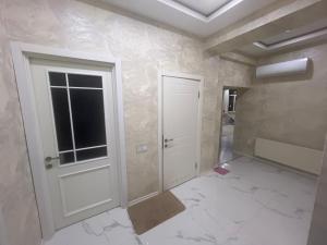an empty room with a door and a window at дом in Baku
