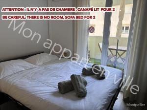 a bedroom with a bed with two tires on it at Mon Appart en Ville in Montpellier