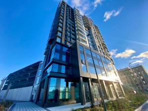 a tall building with a lot of windows at Vektor Premium Apartment with Rooftop Garden & Free Parking in Tallinn