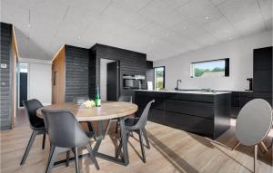 a kitchen and dining room with a table and chairs at 3 Bedroom Lovely Home In Sjølund in Sjølund