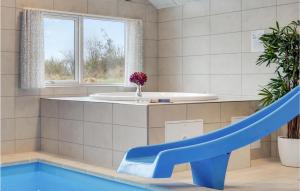 a bathroom with a blue slide and a sink at Awesome Home In Sydals With Sauna in Sarup +26 photos