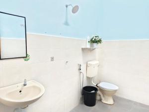 a bathroom with a sink and a toilet and a mirror at NASUHA HOMESTAY 2 TEMERLOH Semi-D House, 4 Bedroom, 2 Bathroom, 4 Unit Aircond, Njoy in Temerloh +9 photos