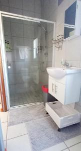 a bathroom with a shower with a sink and a shower at Fynbos Single Stay in Langebaan +21 photos