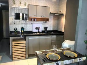 a kitchen with a table with two plates on it at Portuga Flat - Olinda in Olinda