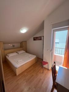 a bedroom with a bed and a large window at Apartments Bojka in Promajna +111 photos