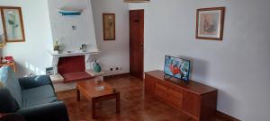 a living room with a couch and a table at SwordFish Cliff Apartment in Peniche