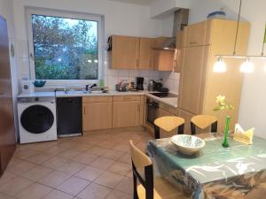 a kitchen with a table and a sink and a dishwasher at Casa Linda in Rotenburg an der Wümme