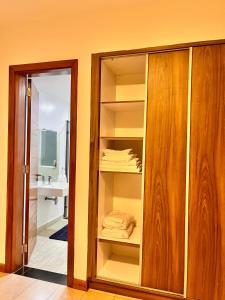 a room with an open cabinet with towels on it at Imagine Luxury Apartments in Nairobi +15 photos