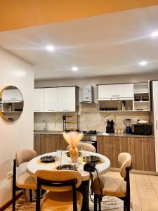a kitchen with a table and chairs in a room at Imagine Luxury Apartments in Nairobi