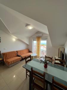a living room with a couch and a table at Apartments Bojka in Promajna