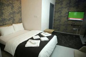 Postel nebo postele na pokoji v ubytování Minimalist Suit Otel