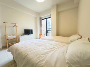 Postel nebo postele na pokoji v ubytování Apple Homestay