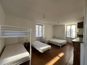a bedroom with two bunk beds and two windows at Proche de SARLAT -Vue exceptionnelle in Carlux +20 photos