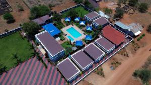 an overhead view of roofs of houses with a pool at Johnsons Villas in Zame