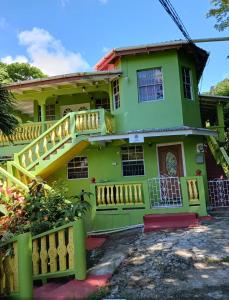 a green house with a staircase in front of it at Fano's Tropical Oasis, Boise D'orange ST Lucia in Castries