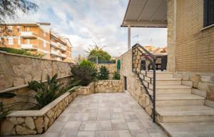 a stairway leading to a house with a stone wall at Fix You Apartment Fco 2 in Fiumicino