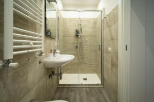 a bathroom with a shower and a sink and a toilet at Fix You Apartment Fco 2 in Fiumicino +38 photos