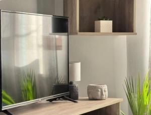 a television sitting on a table in a room at City Palm Retreat in Mytilini +18 photos